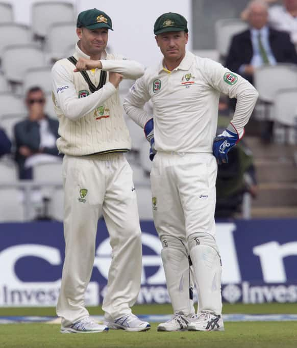 As wicketkeeper Brad Haddin stands by, Australia's Michael Clarke, left, calls for a decision review on the final day of the third Ashes Test series cricket match against England at Old Trafford cricket ground, Manchester.