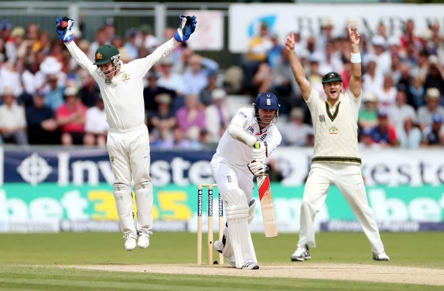 England's James Anderson is caught out by Australia's Brad Haddin, left, during the fourth day of the fourth Ashes series cricket match at the Riverside cricket ground, Chester-le-Street, England.