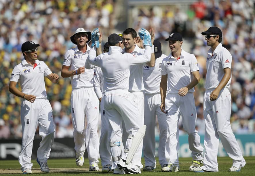 England's James Anderson, centre, celebrates with teammates after taking the wicket of Australia's David Warner during play on the first day of the fifth Ashes cricket Test at the Oval cricket ground in London.