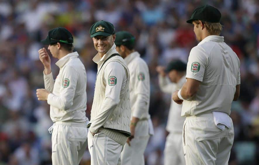 Australia's cricket captain Michael Clarke, second right, smiles as he turns to speak to teammate Shane Watson, left, during play on the second day of the fifth Ashes cricket Test at the Oval cricket ground in London.