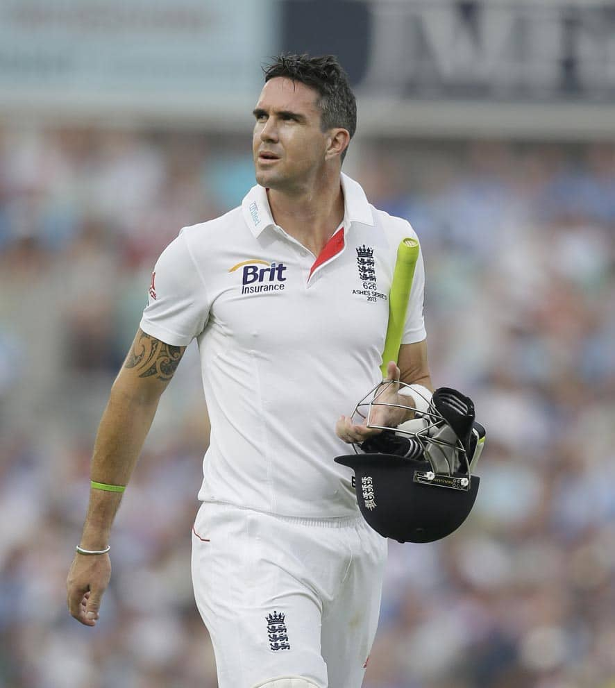 England's Kevin Pietersen walks off the pitch after being given out caught by Australia's Shane Watson off the bowling of Mitchell Starc during play on the third day of the fifth Ashes cricket Test at the Oval cricket ground in London.