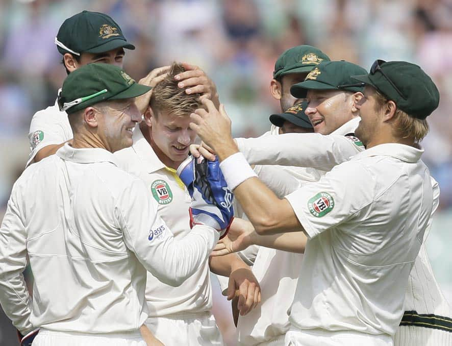 Australia's James Faulkner, centre is congratulated by his teammates after taking the wicket of England's Ian Bell during play on the fifth day of the fifth Ashes cricket Test at the Oval cricket ground in London.