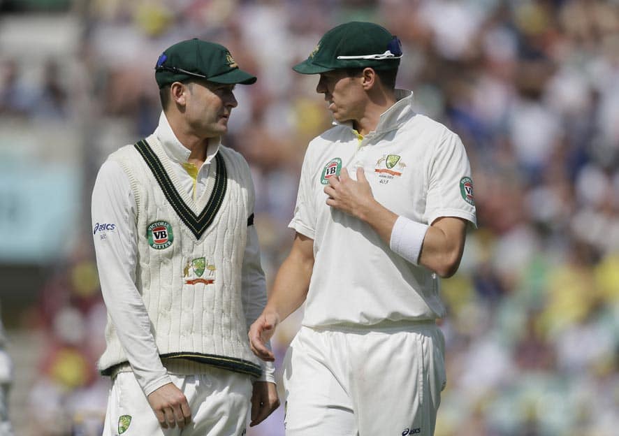 Australia's captain Michael Clarke, left, speaks to his bowler Peter Siddle during play on the fifth day of the fifth Ashes cricket Test against England at the Oval cricket ground in London.