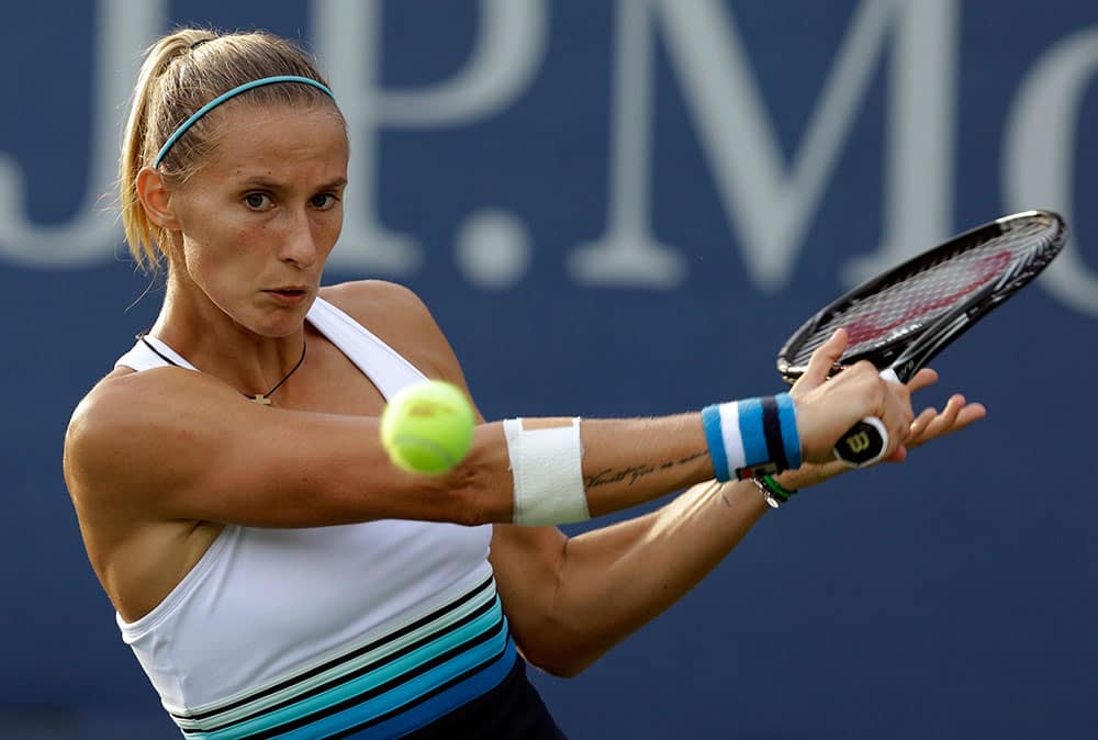 Slovenia's Polona Hercog returns a shot to Ekaterina Makarova, of Russia, during the first round of the 2013 US Open tennis tournament.