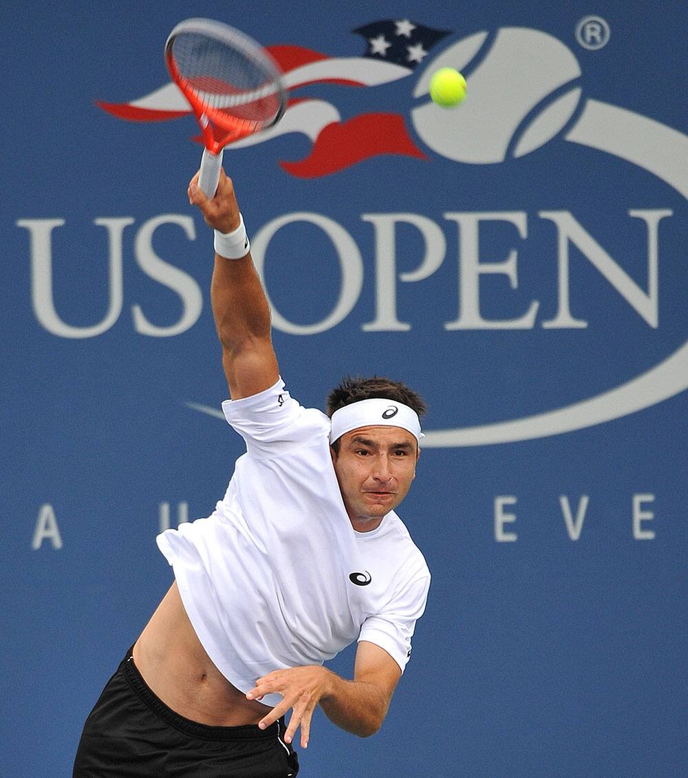 Marinko Matosevic of Australia returns a shot against Tommy Robredo of Spain during the first round of the 2013 US Open tennis tournament.