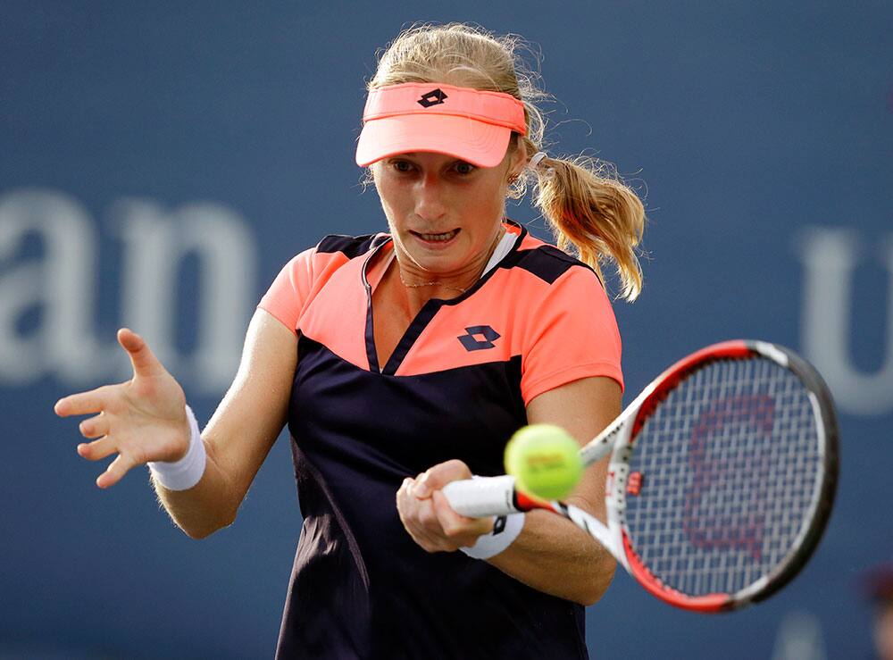 Ekaterina Makarova, of Russia, returns a shot to Slovenia's Polona Hercog during the first round of the 2013 US Open tennis tournament.