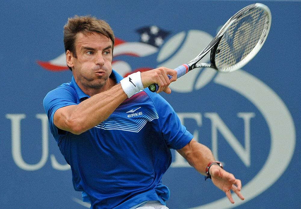 Tommy Robredo of Spain returns a shot against Marinko Matosevic of Australia during the first round of the 2013 US Open tennis tournament.