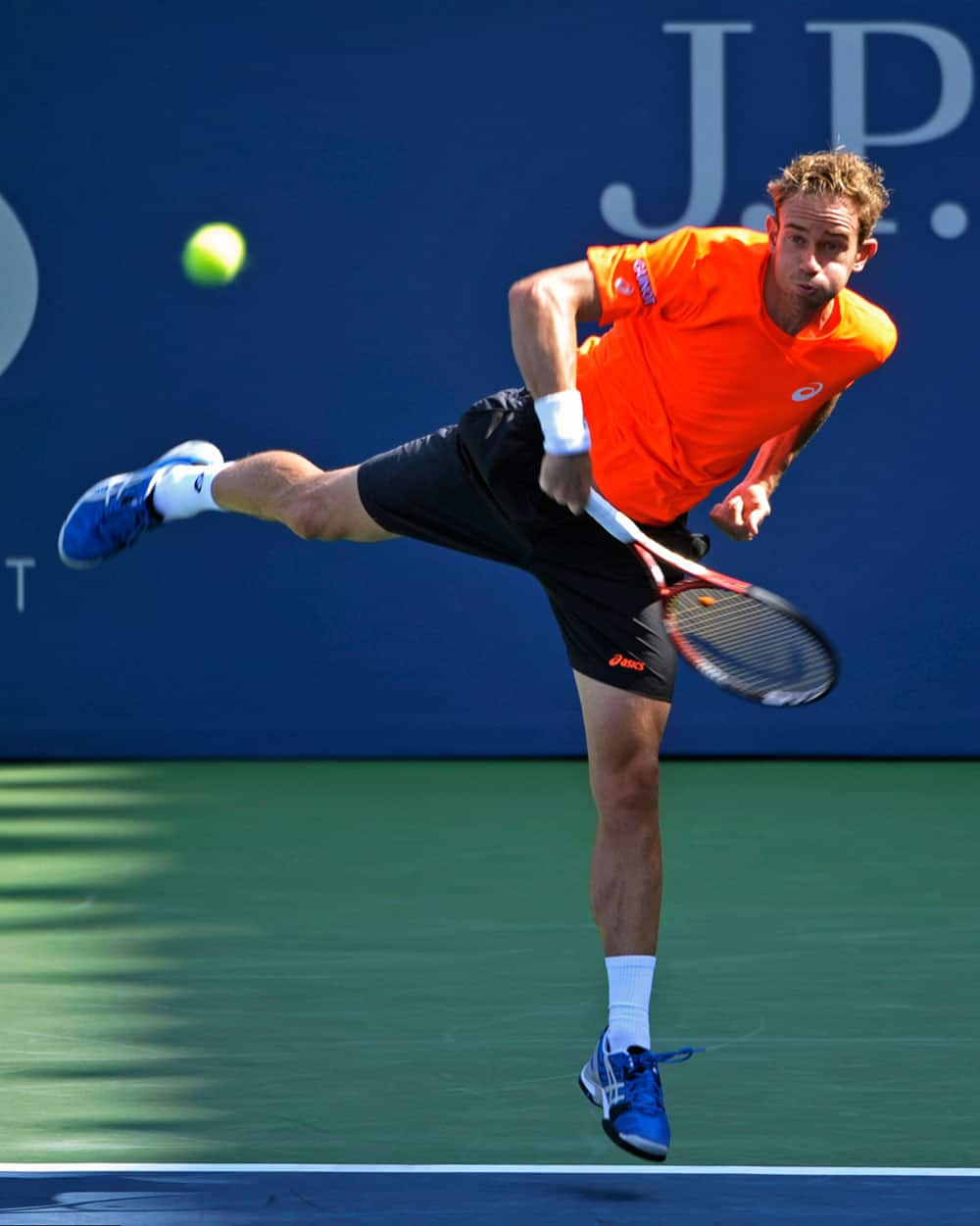 Filippo Volandri, of Italy, returns a shot to John Isner during the first round of the 2013 US Open tennis tournament.