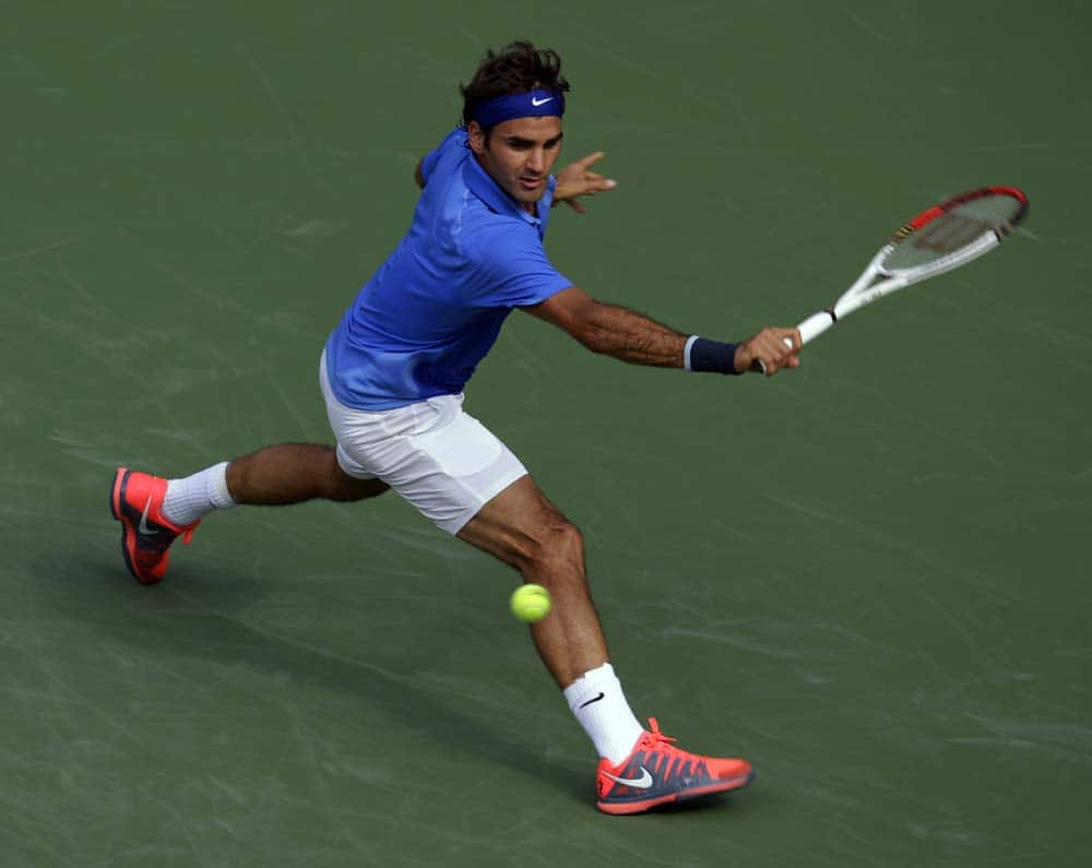 Roger Federer, of Switzerland, returns a shot to Carlos Berlocq, of Argentina, during the second round of the 2013 US Open tennis tournament.