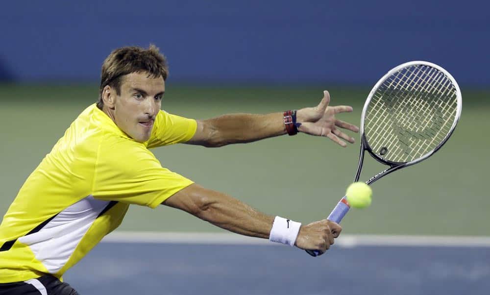 Spain's Tommy Robredo returns a shot to Daniel Evans, of Great Britain, during a third round match at the US Open tennis tournament.