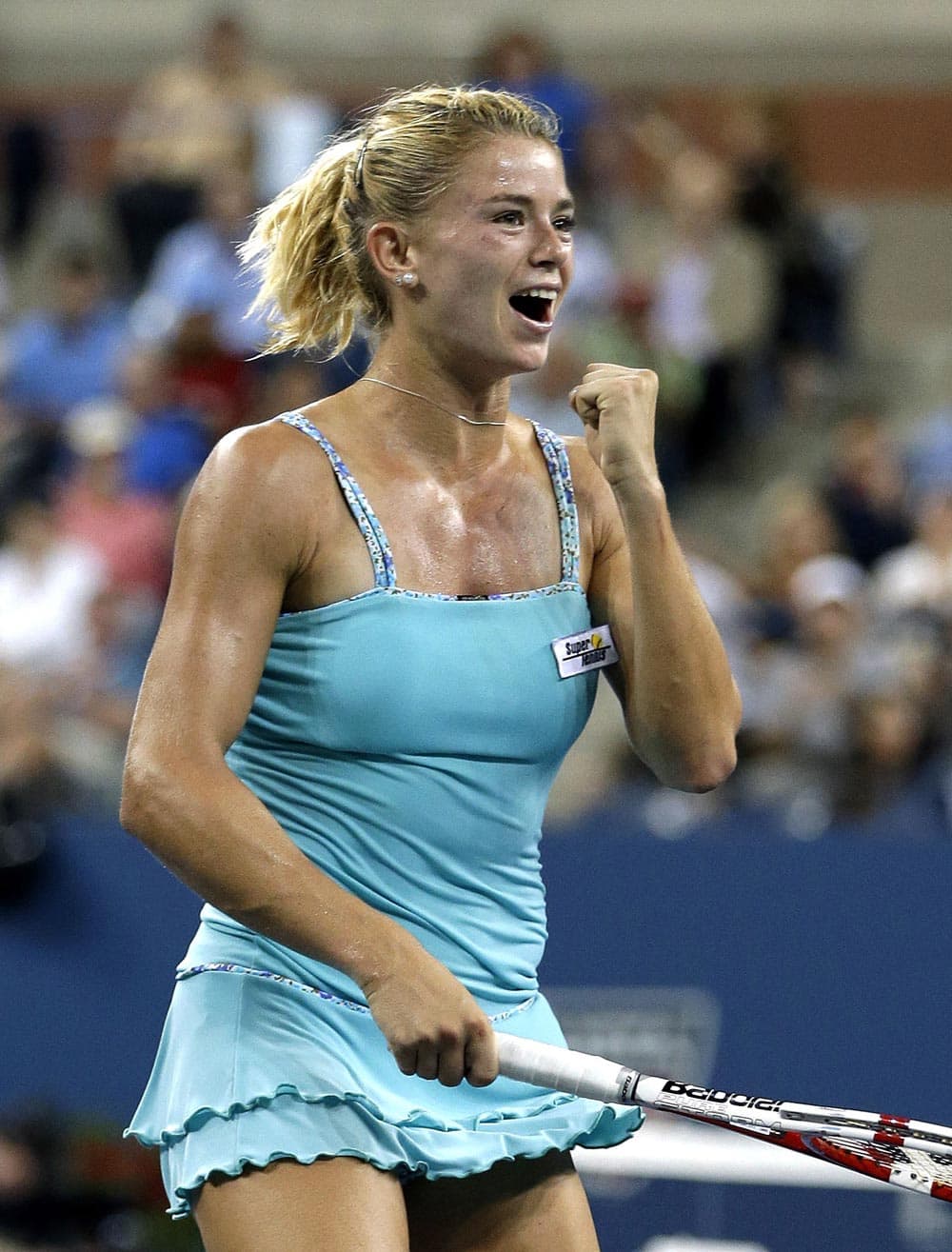 Camila Giorgi, of Italy, reacts after defeating Caroline Wozniacki, Denmark, in a third round match at the US Open tennis tournament.