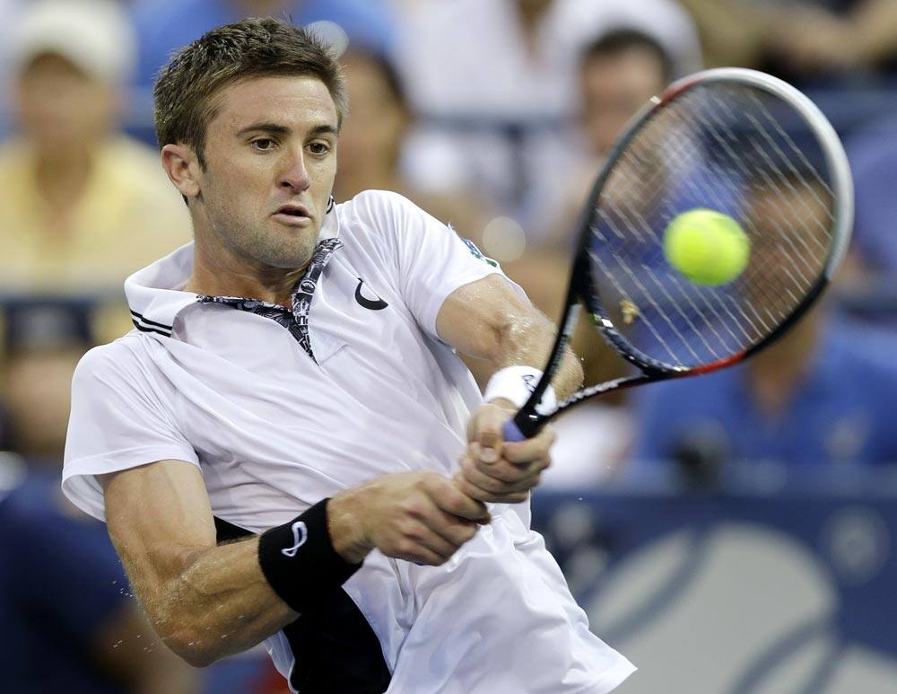 Tim Smyczek returns a shot against Marcel Granollers of Spain during the third round of the 2013 US Open tennis tournament.