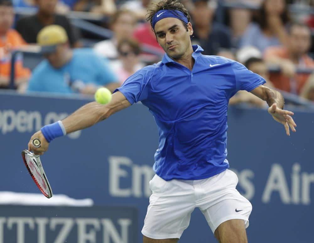 Roger Federer, of Switzerland, returns a shot to Tommy Robredo, of Spain, during the fourth round of the 2013 US Open tennis tournament.