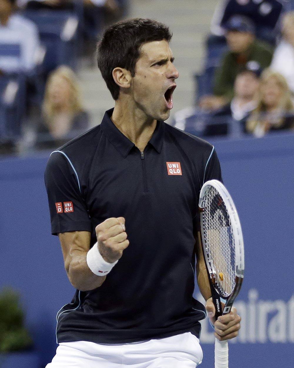 Novak Djokovic, Serbia, reacts following a shot during a quarterfinal match against Mikhail Youzhny, Russia, at the 2013 US Open tennis tournament.