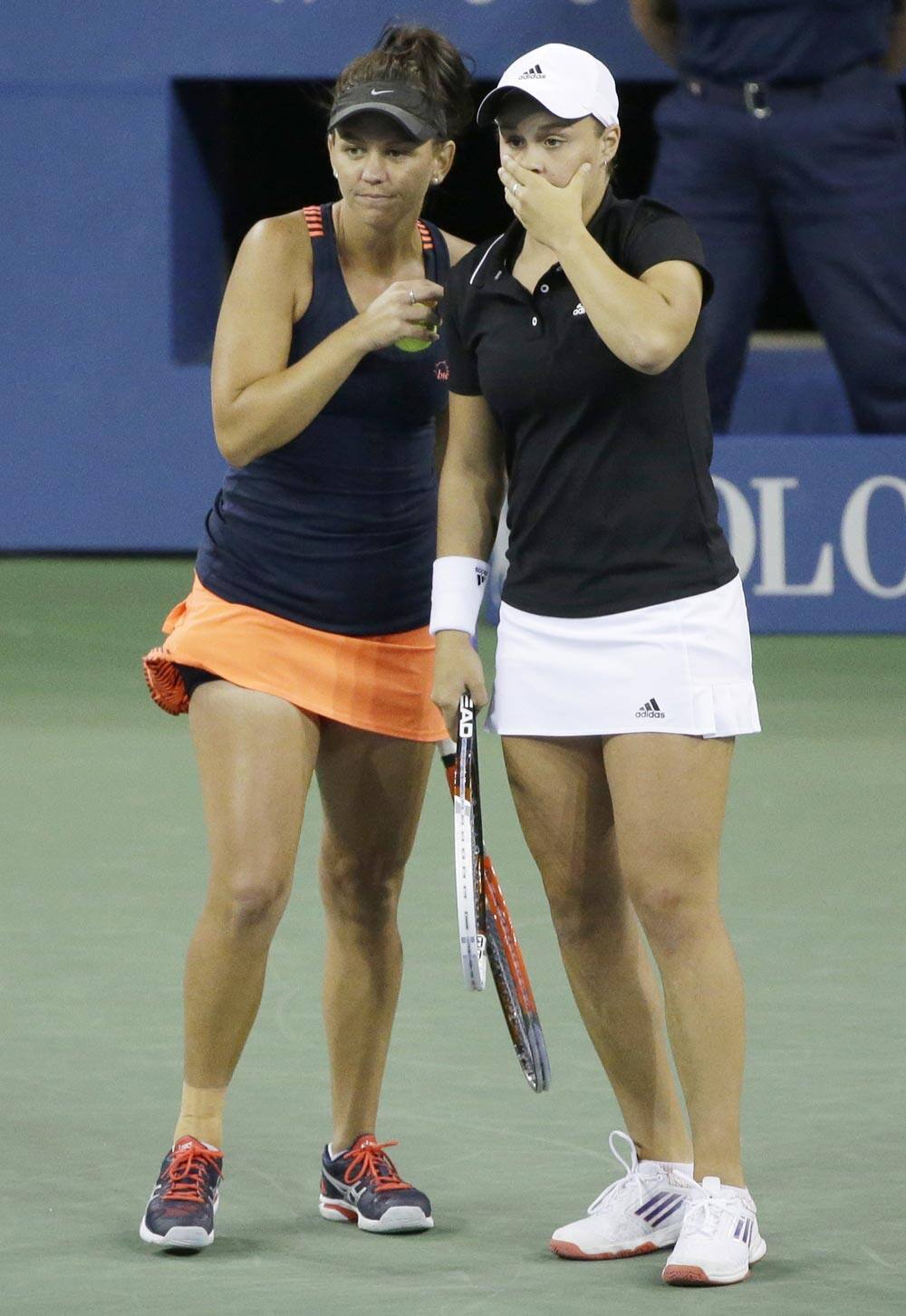 Casey Dellacqua and Ashleigh Barty of Australia plan the next point against Andrea Hlavackova and Lucie Hradecka, of the Czech Republic, during the women's doubles final of the 2013 US Open tennis tournament.