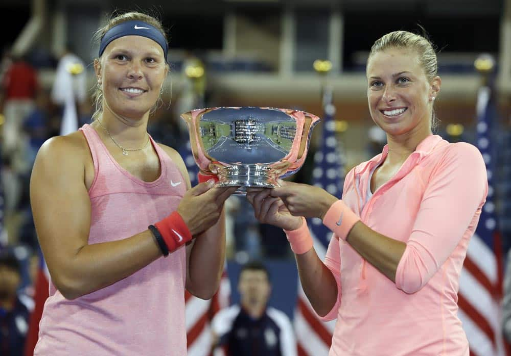 Lucie Hradecka and Andrea Hlavackova, of the Czech Republic, hold the championship trophy after defeating Ashleigh Barty and Casey Dellacqua of Australia in the women's doubles final of the 2013 US Open tennis tournament.