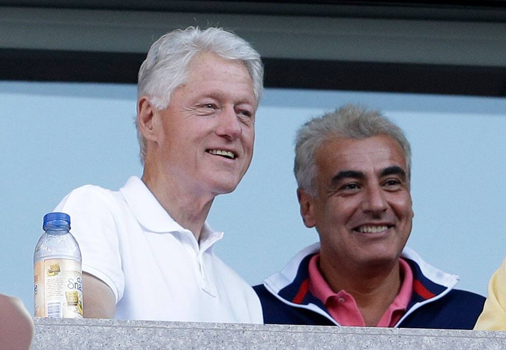 Former president Bill Clinton, left, watches play between Victoria Azarenka, of Belarus, and Serena Williams during the women's singles final of the 2013 US Open tennis tournament.