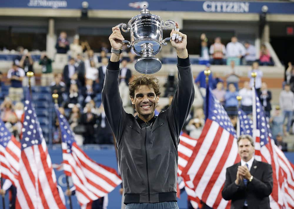 Rafael Nadal, of Spain, holds up the championship trophy after winning the men's singles final over Novak Djokovic, of Serbia, at the 2013 US Open tennis tournament.