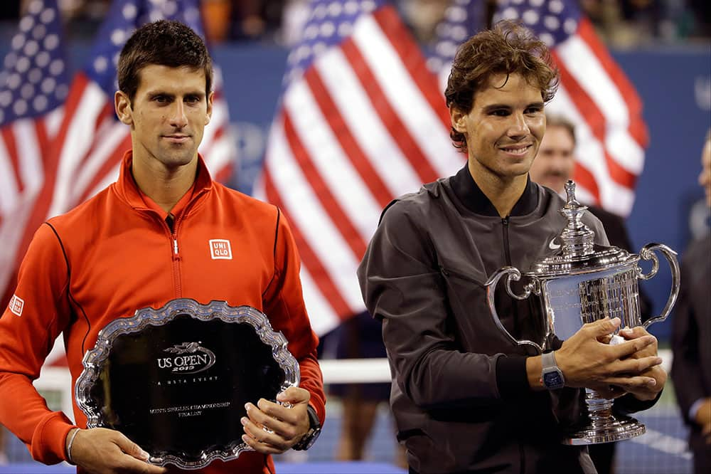 Novak Djokovic, of Serbia, and Rafael Nadal, of Spain, pose for photos after Nadal won the men's singles final of the 2013 US Open tennis tournament.