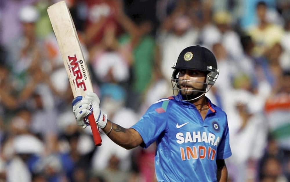 Virat Kohli celebrates his fifty against Australia during the 3rd ODI cricket match at PCA stadium in Mohali.