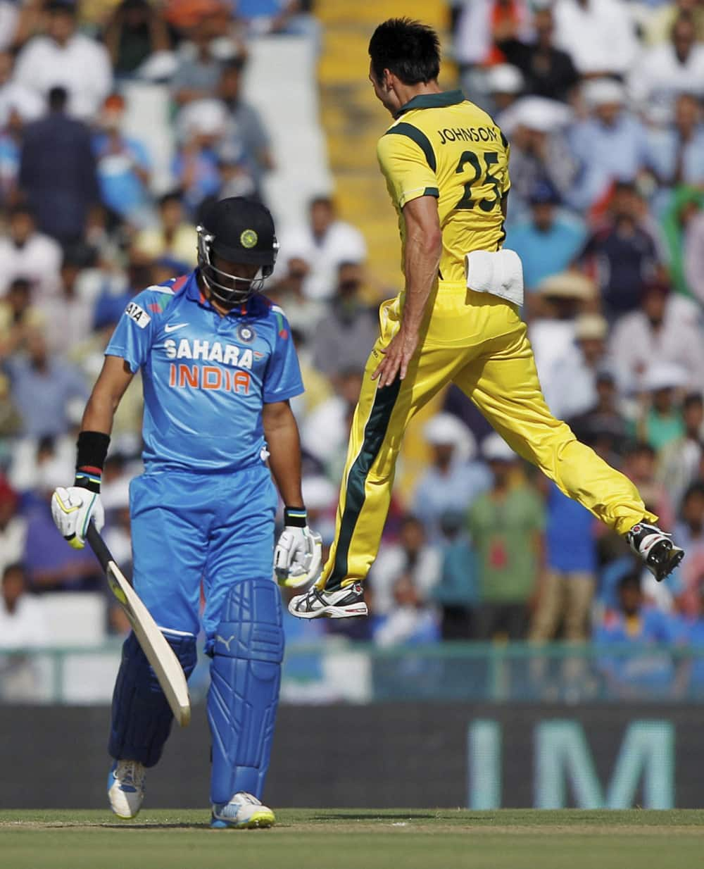 M Johnson exults after taking wicket of Indian batsman Yuvraj Singh (L) during their 3rd ODI cricket match at PCA stadium in Mohali.