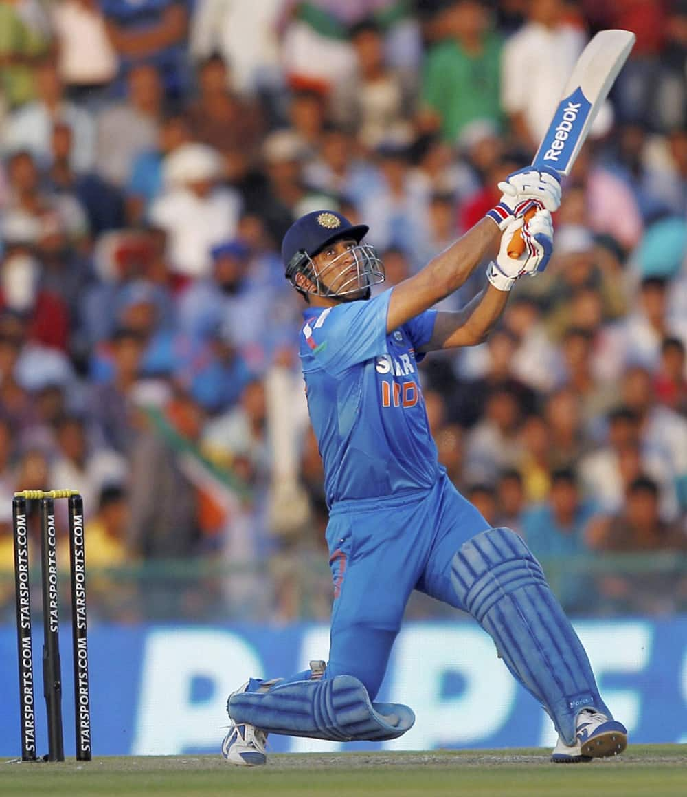 MS Dhoni plays a shot against Australia during the 3rd ODI cricket match at PCA stadium in Mohali.