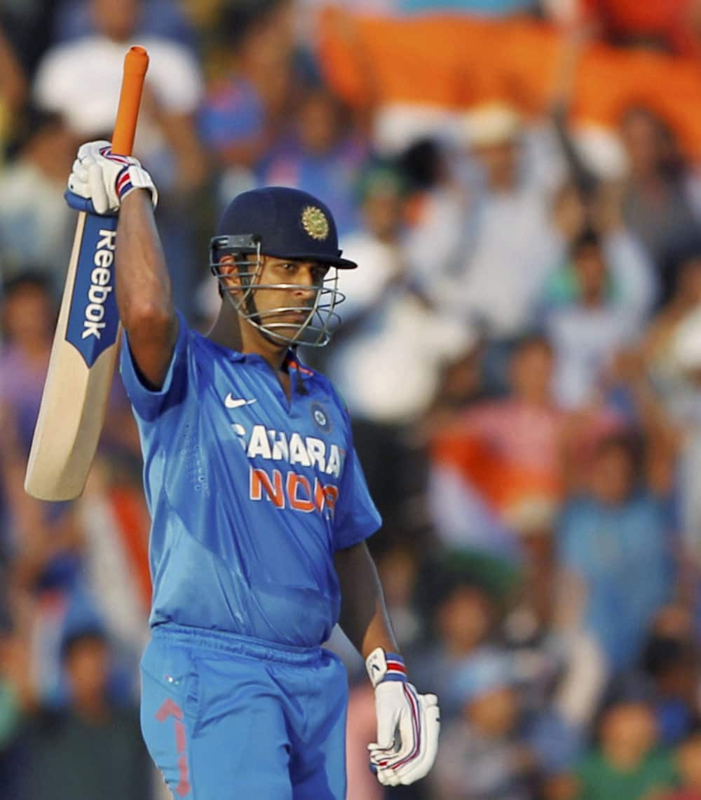 MS Dhoni celebrates after scoring century against Australia in the 3rd ODI cricket match at PCA stadium in Mohali.