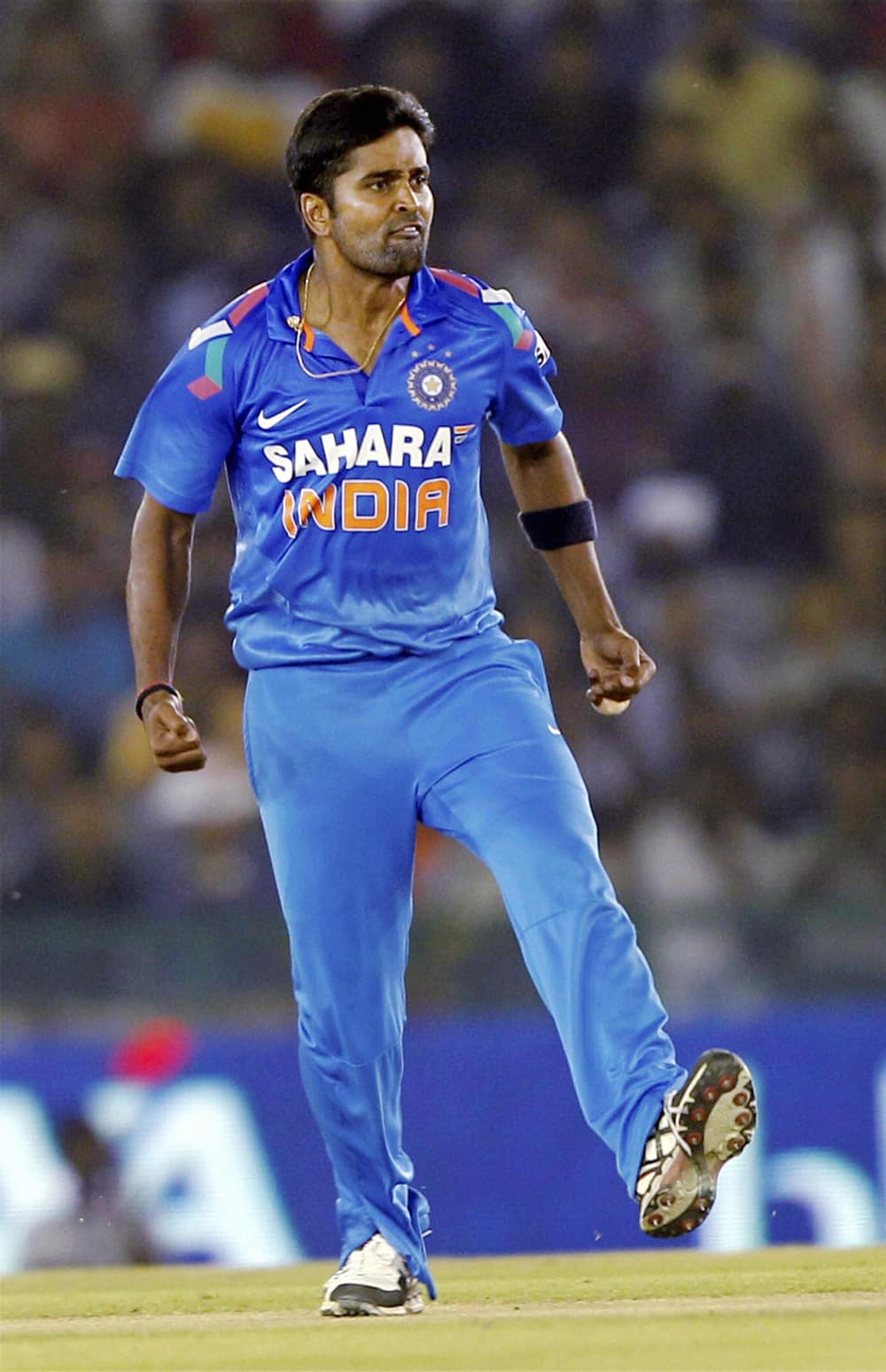 R Vinay Kumar of India reacts after taking the wicket of Australian batsman PJ Hughes during the 3rd ODI match at PCA stadium in Mohali.