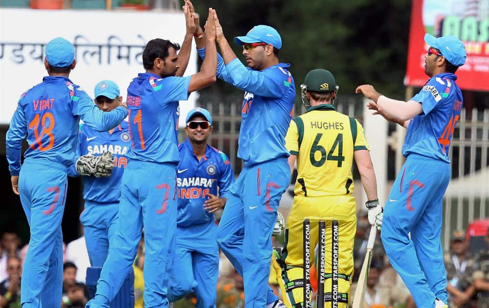 M Shami celebrates with teammates after claiming the wicket of Australia's A Finch during the 4th ODI cricket match in Ranchi.