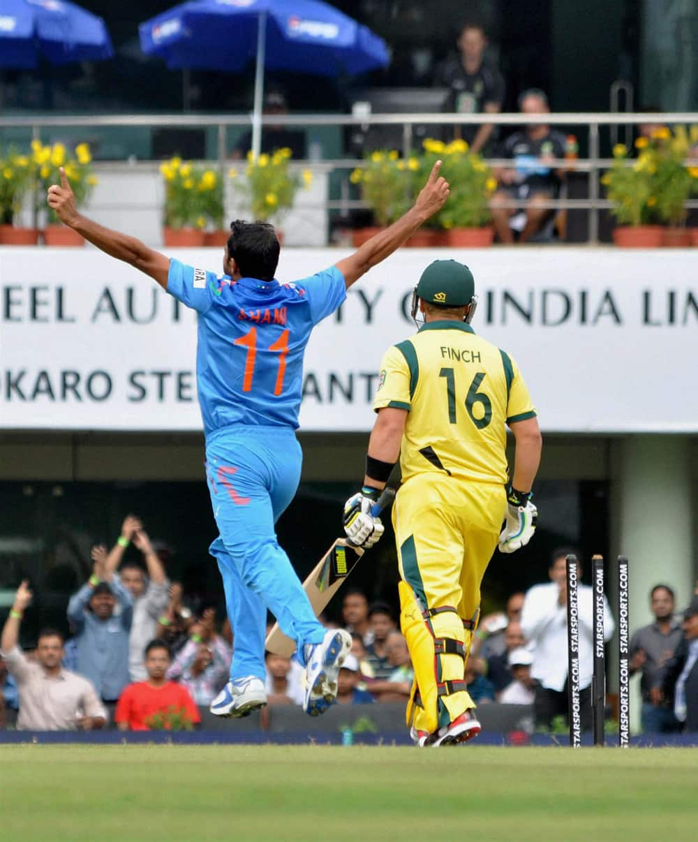 M Shami reacts after claiming the wicket of Australia's A Finch (R) during the 4th ODI cricket match in Ranchi.