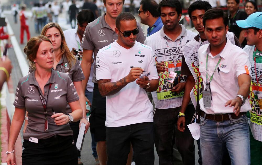 Mercedes driver Lewis Hamilton of Britain walks down pit lane to a autograph signing session ahead of the Indian Formula One Grand Prix at the Buddh International Circuit in Noida.