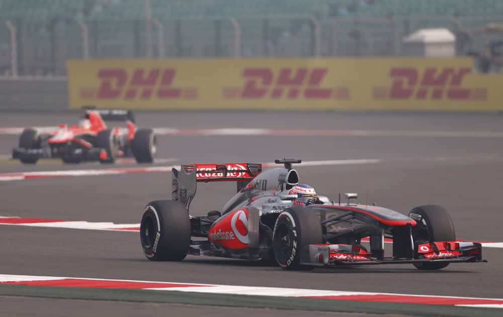 McLaren Mercedes driver Jenson Button of Britain steers his car during the first practice session at the Indian Formula One Grand Prix at the Buddh International Circuit in Noida.