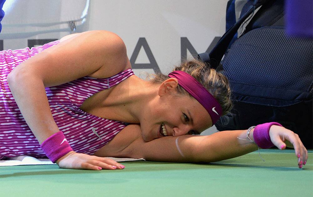 Victoria Azarenka of Belarus lies on the ground after she was injured during her tennis match with Li Na of China at the WTA Championship in Istanbul, Turkey.