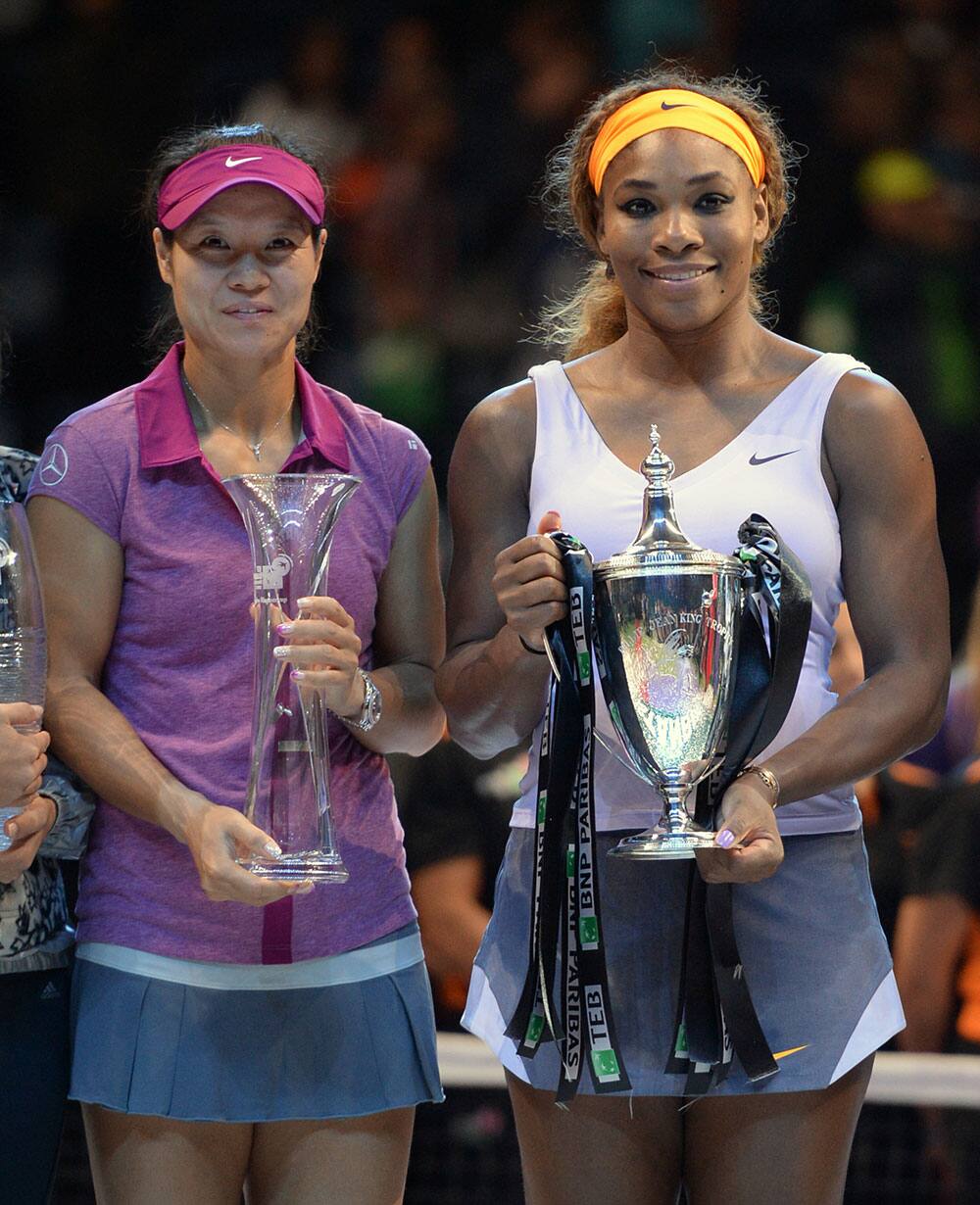 Serena Williams of the USA holds her trophy after her victory over Li Na of China, left, in the final of the WTA Championship in Istanbul, Turkey.