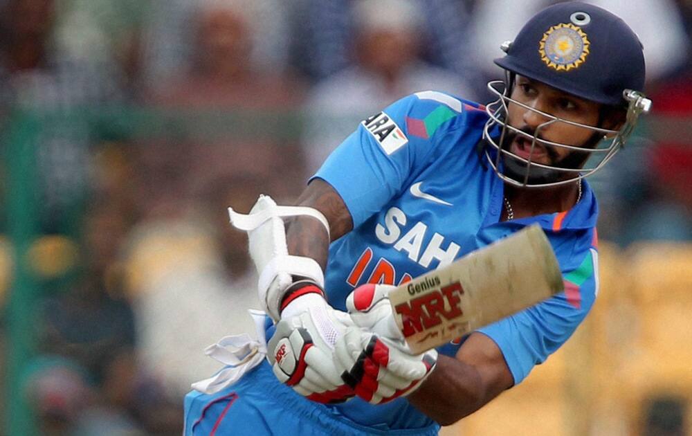 Shikhar Dhawan plays a shot during the 7th ODI against Australia at Chinnaswamy stadium in Bengaluru.