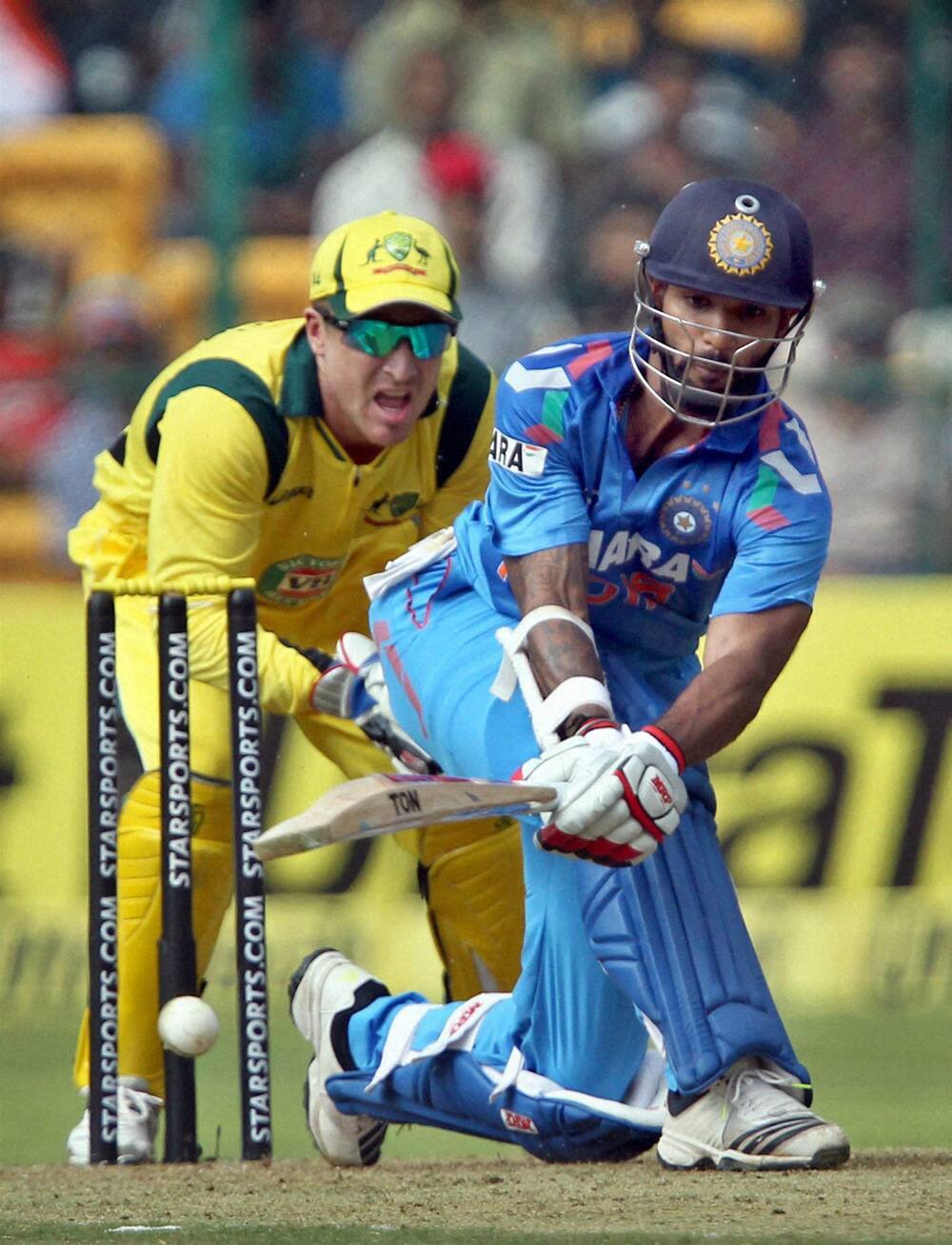 Shikhar Dhawan plays a shot during the 7th ODI against Australia at Chinnaswamy stadium in Bengaluru.