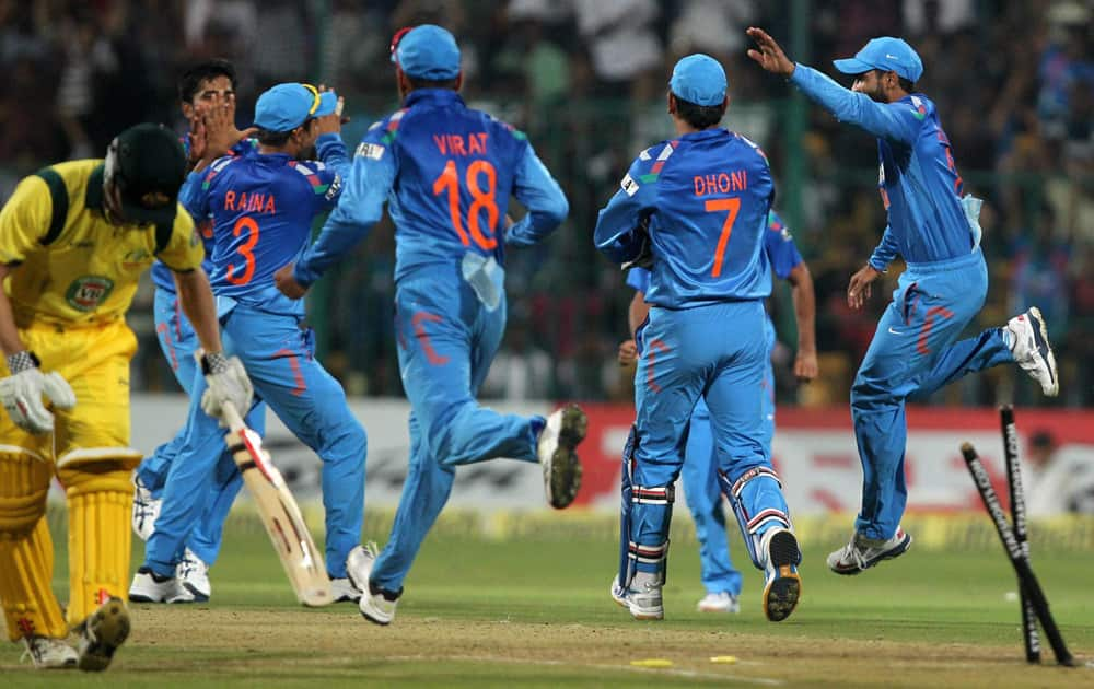 Indian players celebrate the wicket of George Bailey during the 7th ODI against Australia at Chinnaswamy stadium in Bengaluru.