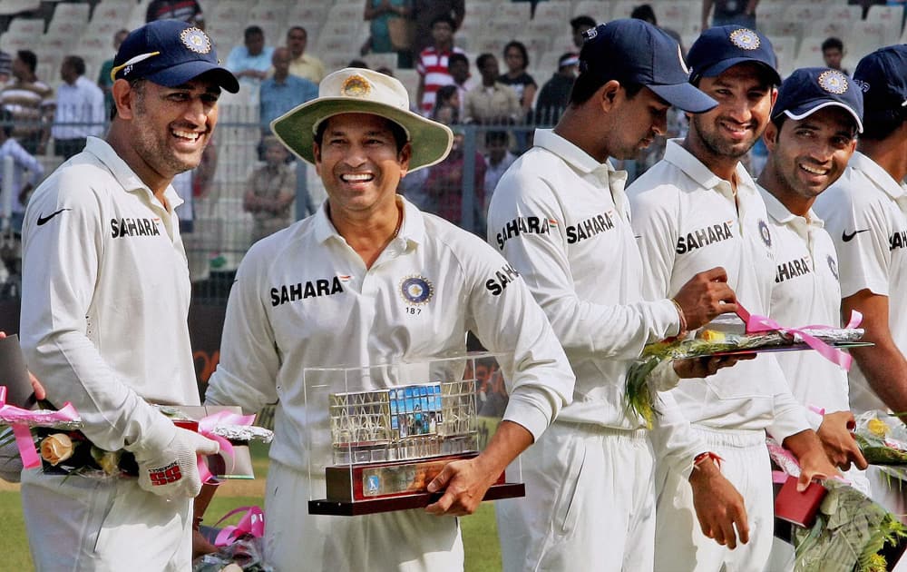 Sachin Tendulkar with captain Mahendra Singh Dhoni and others after being felicitated at Eden Garden in Kolkata, during the first test match between India and West Indies.