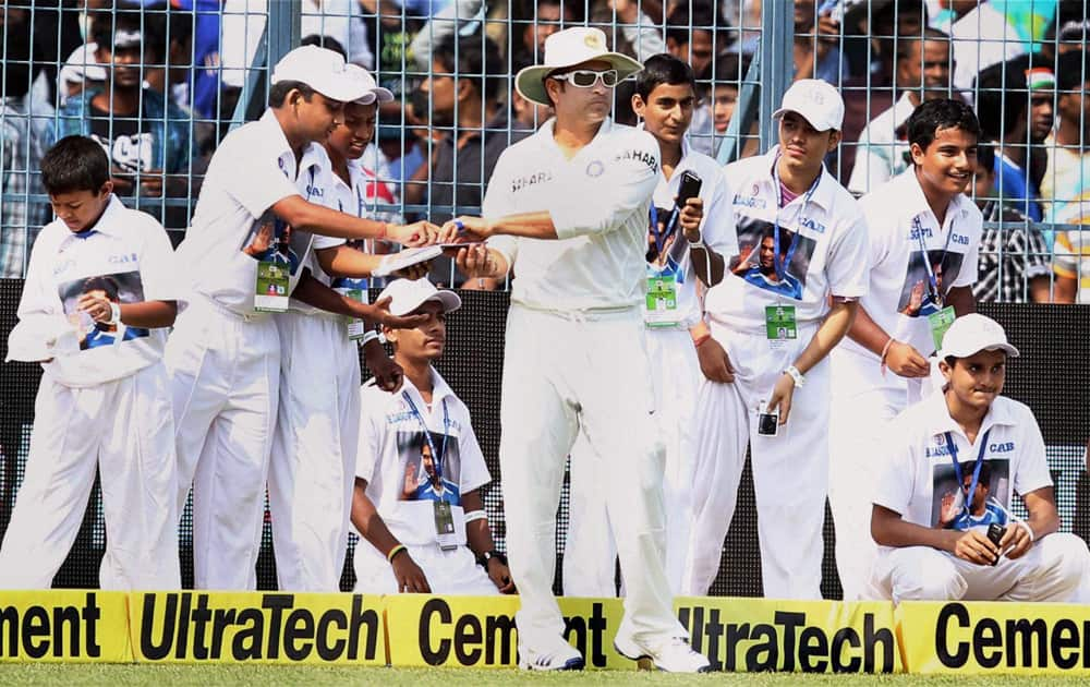 Sachin Tendulkar signs autographs at Eden Garden during the first day of the first test match between India and West Indies in Kolkata.