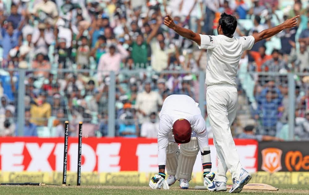 Mohammed Shami celebrates the dismissal of West Indies batsman R.Ramdin on the first day of first Test Match at Eden Garden in Kolkata.