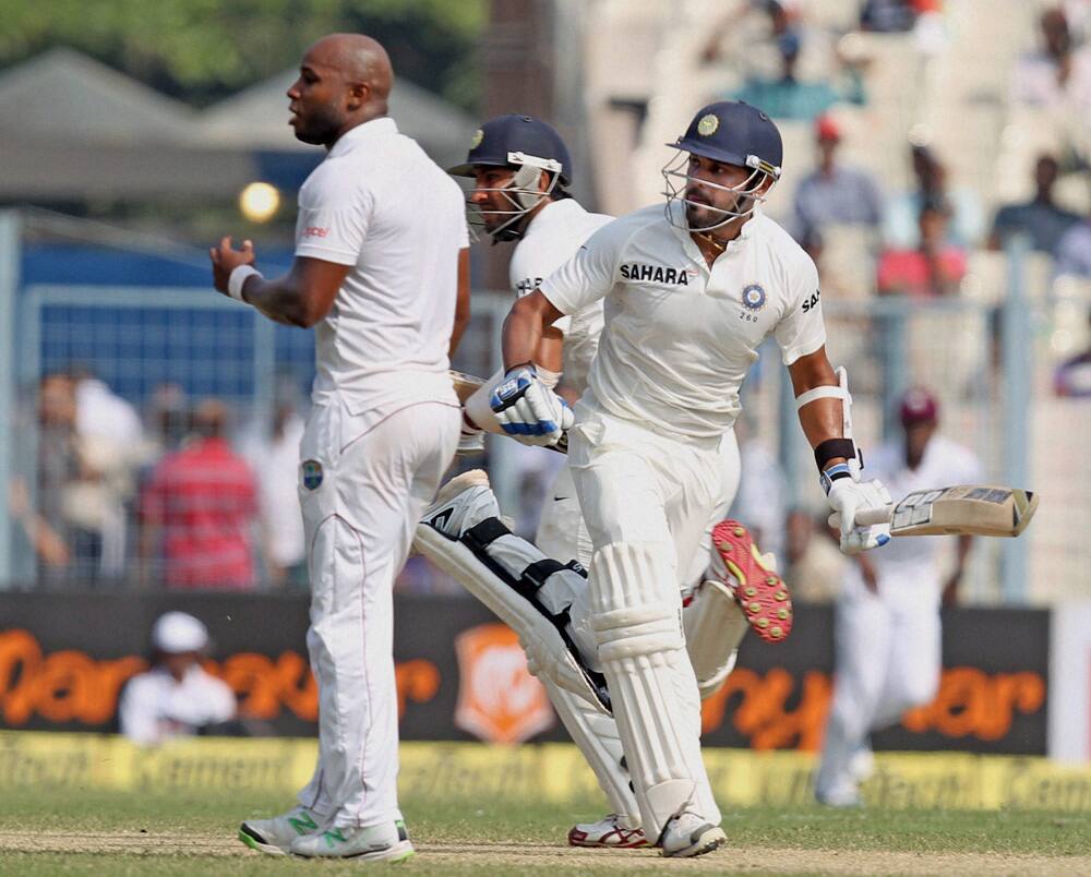 Cheteshwar Pujara and M.Vijay in action on the second day of the first test match at Eden Garden in Kolkata.