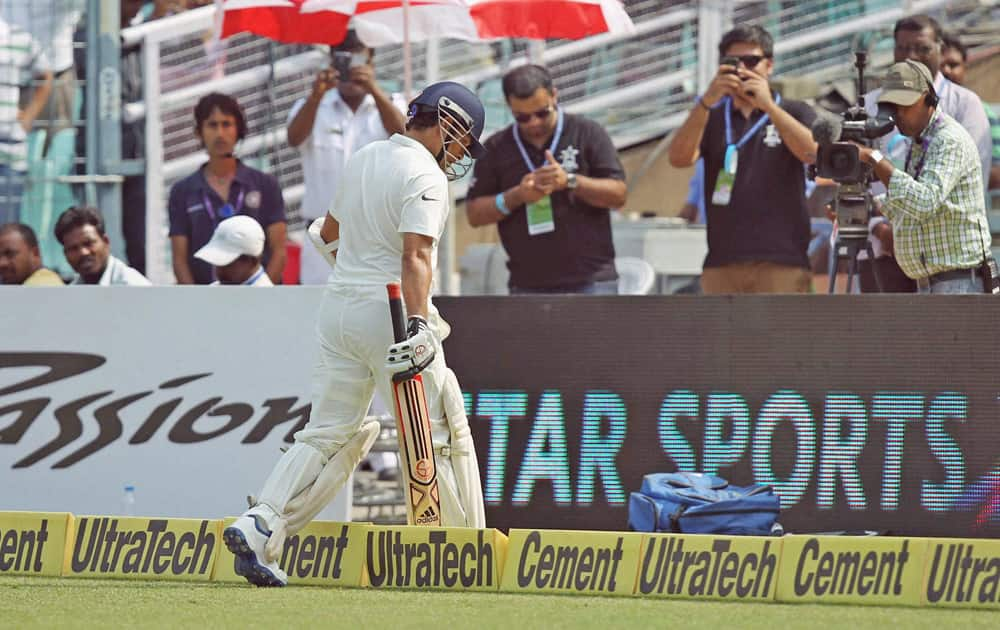 Sachin Tendulkar walks out after being dismissed.