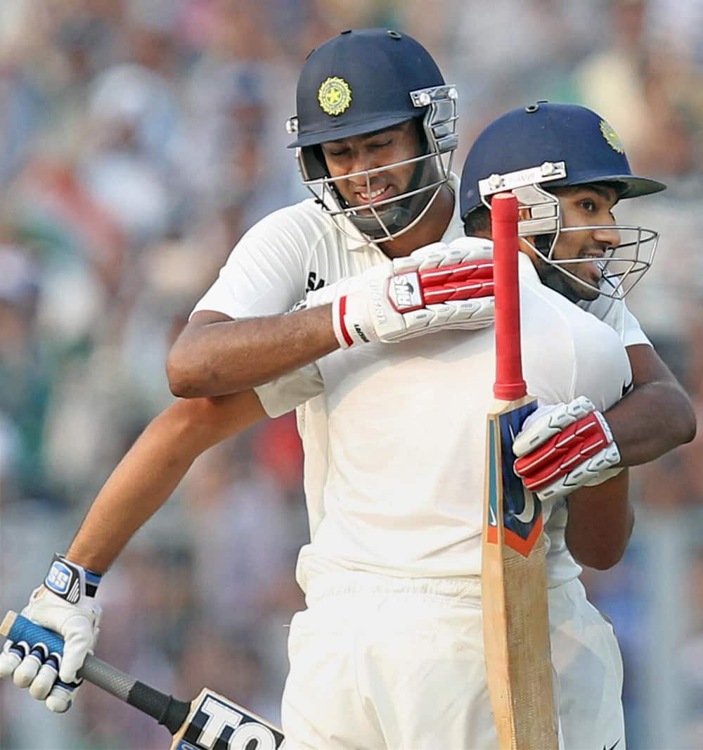 Rohit Sharma is congratulated by his teammate R Ashwin after scoring a century during Frist Test match 2nd day againist West Indies in Kolkata.