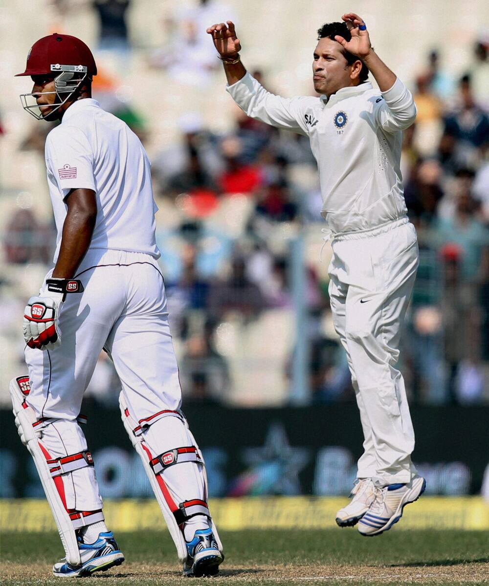 Sachin Tendulkar reacts after bowling a delivery during the 3rd day of the first Test Match against West Indies at Eden Garden in Kolkata.