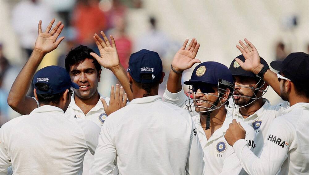 Ravichandran Ashwin celebrates with teammates after dismissing West Indies batsman D Bravo on 3rd day of the first test match at Eden Garden in Kolkata.