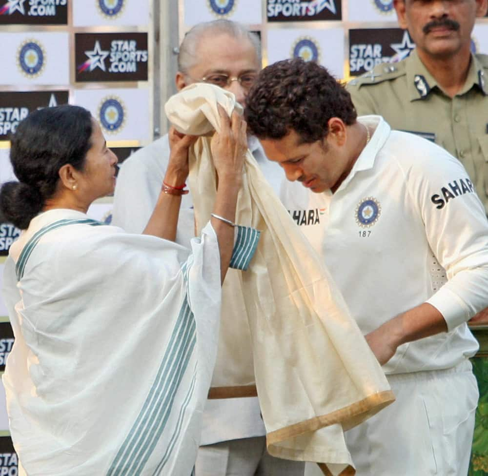 West Bengal Chief Minister Mamata Banerjee honours master blaster Sachin Tendulkar at the presentation ceremony after the end of the first Test match against West Indies at Eden Garden in Kolkata.