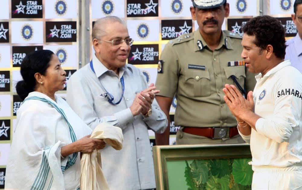 West Bengal Chief Minister Mamata Banerjee honours master blaster Sachin Tendulkar at the presentation ceremony after the end of the first Test match against West Indies at Eden Garden in Kolkata.