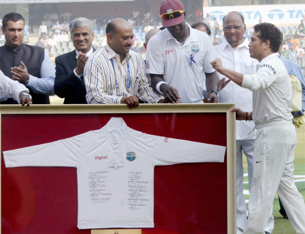 West Indies Captain Darren Sammy presents team t-shirt to Master blaster Sachin Tendulkar during his 200th and final Test match against West Indies from November 14-18. 