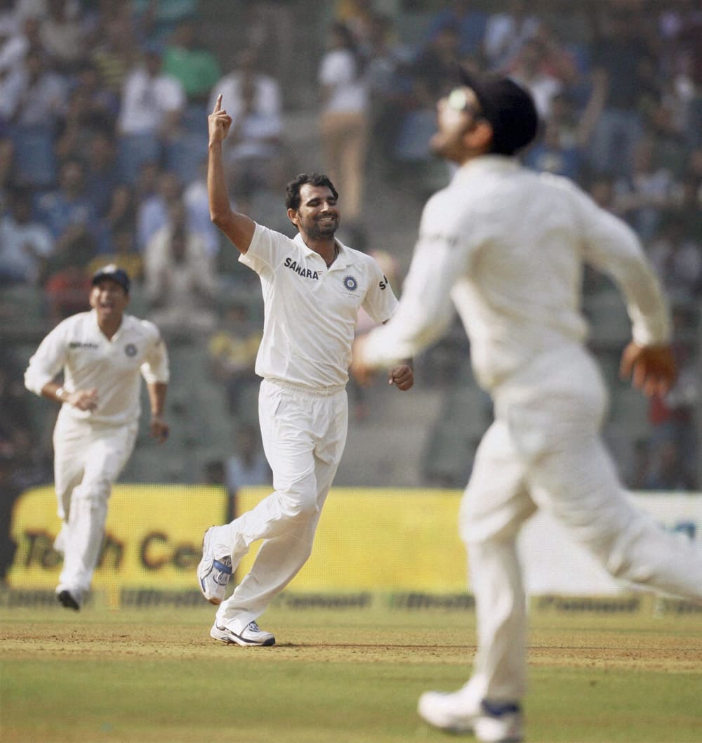 Mohammed Shami celebrates the wicket of West Indian batsman Chris Gayle on the first day of the final test match at Wankhede stadium in Mumbai.