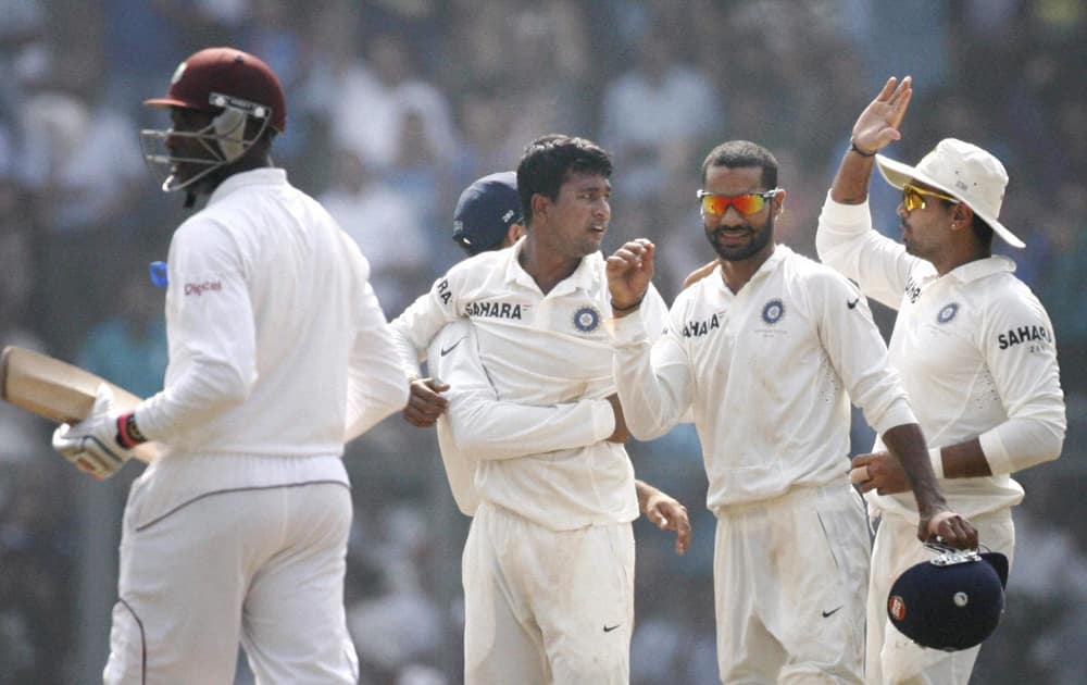 P Ojha celebrates with teammates after dismissing a West Indies batsman during Day 1 of the 2nd and final test match at Wankhede in Mumbai.